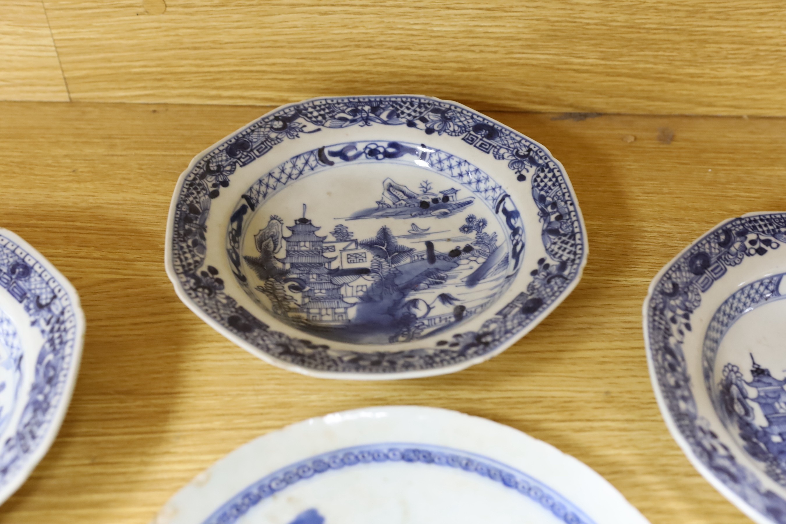 A selection of severn 18th century Chinese export blue and white dishes, largest 35cm wide